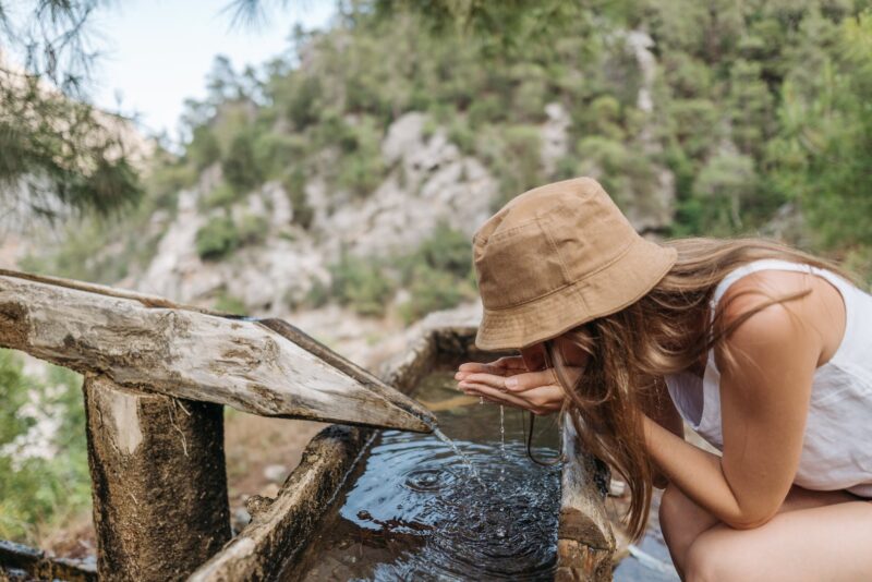 Woman Drinking Water From On Wood
